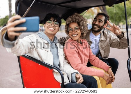 Multiracial young friends having fun taking selfie together on vacation while sightseeing tourist city on taxi tuk tuk - Friendship, travel tour and tourism concept