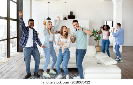 Multiracial young friends having party, dancing and drinking beer, having fun together at home, panorama. Cheerful international fellow students enjoying social gathering, moving to favorite music - Powered by Shutterstock