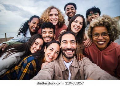 Multiracial young group of happy people taking selfie portrait - Millennial diverse friends laughing and having fun together - Shutterstock ID 2194833057