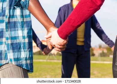 Multiracial Young People Holding Hands in a Circle
