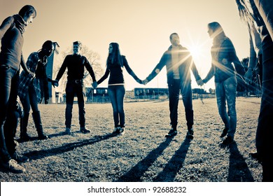 Multiracial Young People Holding Hands in a Circle - Shutterstock ID 92688232