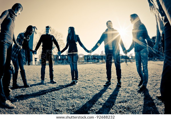 Multiracial Young\
People Holding Hands in a\
Circle