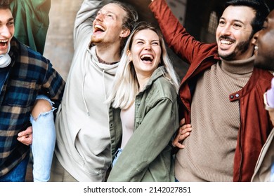 Multiracial young people laughing and celebrating victory event outside - Happy group of friends having fun together walking on city street - Friendship concept with guys and girls enjoying day out  - Powered by Shutterstock