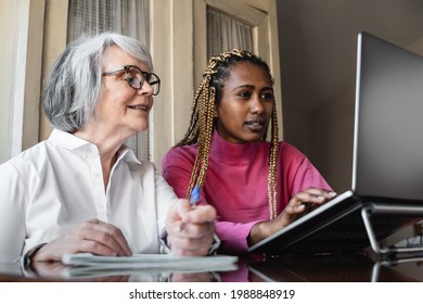 Multiracial Young And Senior People Using Computer Laptop Indoor At Home - Multi Generational People Working Inside Office - Focus On African Girl Face