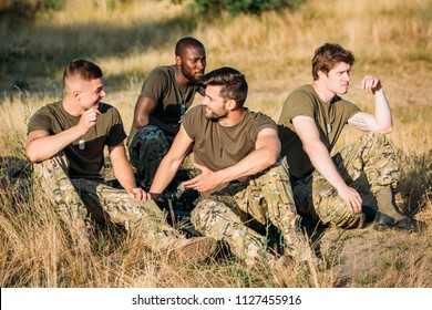 multiracial young soldiers in military uniform resting on range - Shutterstock ID 1127455916