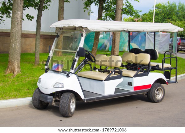 Multi-seat Golf cart. Electric car for\
excursions in the Park. Transportation of\
people.