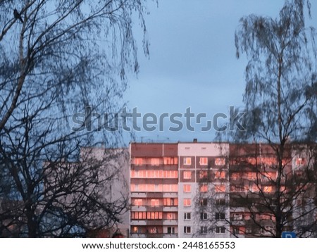 Multi-storey, multi-apartment residential building. Soviet period built in the seventies - eighties of the twentieth century. Red Sunset, evening time.