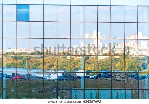 Multistorey specular\
skyscraper building face with skyline and parking reflection.\
Moscow, Russia.\
