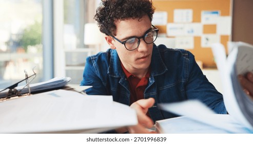Multitask, stack or man in office with document, task or deadline pressure in management review. Busy, organize or marketing intern in agency with glasses, paper check or crisis control in time limit