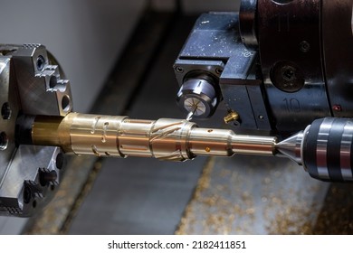 The Multi-tasking CNC Lathe Machine  Groove Cutting The Brass Shaft Parts By Milling Spindle. The High Technology Metal Working With CNC Turning Machine.