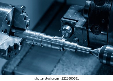 The multi-tasking CNC lathe machine  groove cutting the brass shaft parts by milling spindle. The high technology metal working with CNC turning machine. - Shutterstock ID 2226680581