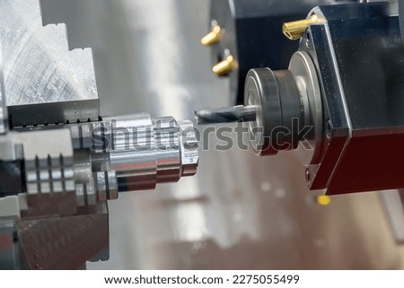 The multi-tasking CNC lathe machine  milling cut the metal shaft parts by milling turret. The high technology metal working with CNC turning machine. Сток-фото © 