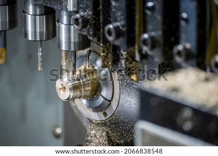 The multi-tasking CNC lathe machine tapping the brass fitting parts. The hi technology parts manufacturing process by multi-tasking CNC turning machine.