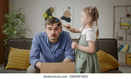 Multitasking Dad Gets Styled by Daughter While Working from Home