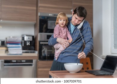 Multitasking Father Is Babysitting And Working At Home.