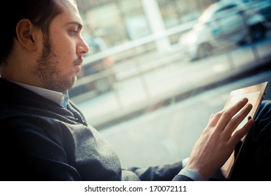 multitasking man using tablet, laptop and cellphone connecting wifi - Powered by Shutterstock