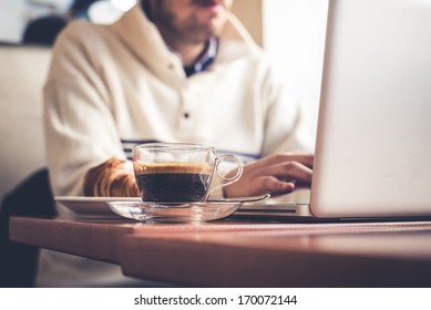 multitasking man using tablet, laptop and cellphone connecting wifi - Powered by Shutterstock