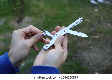 
Multitool Held By A Man. Swiss Army Knife