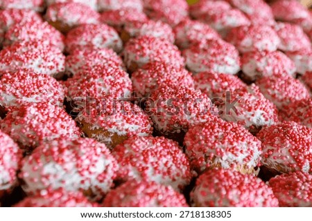 A multitude of Easter cakes on the baking line. A bakery workshop with specialized equipment.