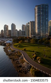 Multi-use recreation path winds along the shore of False Creek in Coopers Park, in Yaletown, Downtown Vancouver, British Columbia, Canada