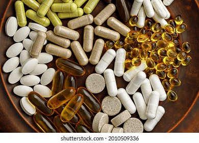 multivitamin dietary supplements on a clay plate. dietary supplements top view. mental wellbeing and personal health concept
