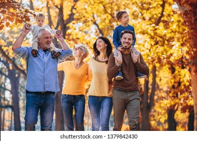 Multl Generation Family In Autumn Park Having Fun