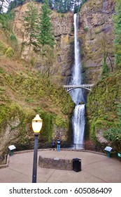 Multnomah Falls and its viewing area including a lighted lamp. The two tiered 611 foot waterfall (542 upper & 69 lower) is along the Columbia River Gorge 30 minutes east of Portland, Oregon.