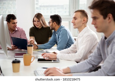 Multy-ethnic Group Of Business People Working At The Office Desk