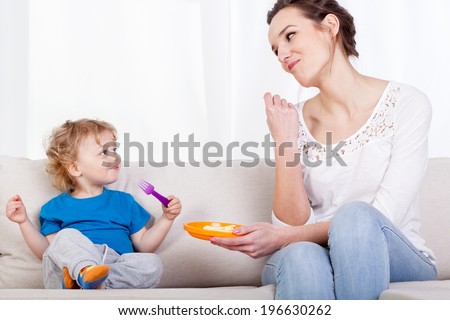 Similar – Mother with eating toddler.