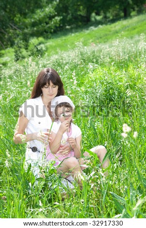 Mum and daughter in a green grass