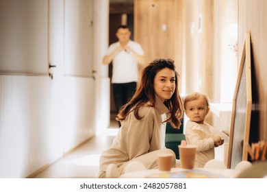 Mum and daughter painting while waiting in hospital - Powered by Shutterstock