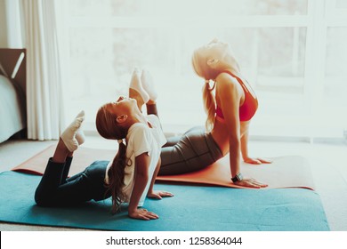 Mum And Daughter Training Stretch. Heel Touch. Yoga Concept. Beauty And Grace. Active Lifestyle. Relaxing Together. Doing Fitness At Home. Holiday Leisure. Flexible Body. Sport Exercise.