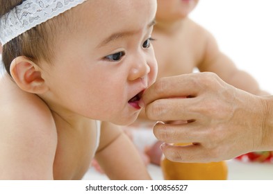 Mum Feeding Asian Baby Snacks