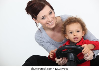 Mum And Son Playing With A Toy Car