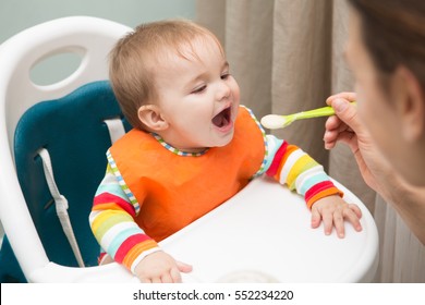 Mum Spoon-feeds The Baby

