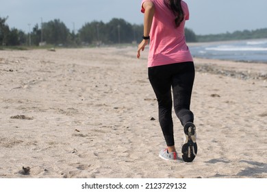 Mumbai, India - 15 August 2021, A Woman Running At A Beach. Jogging, Yoga, Workout, Exercise, Healthy Life, Diet, Lifestyle, Sedentary, Active, Fit, Fresh, Fitness, Periods, Sunlight, Muscle Concept.