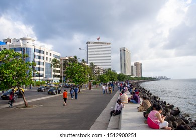 Mumbai, India, August 2019: A Large Amount Of People Roaming The Street Of Mumbai Near Marine Drive After A Heavy Rainfall Stops . Marine Drive Is A Famous Tourist Attraction In Mumbai.