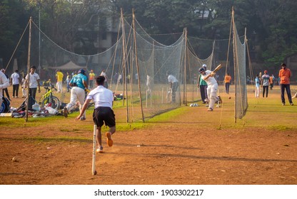 Mumbai, India - December 20, 2020: Unidentified boys practicing batting and bowling to improve cricketing skills at Mumbai ground