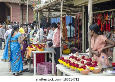 Mumbai, India - February 21,  2014 -  Vendors selling flowers,  garlands and coconuts along the street in front of Hindu temple during daytime