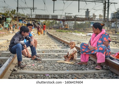 Mumbai, India - February 26, 2019: Indian People On Railroad Near Suburban Railway In Dharavi Slum At Mumbai