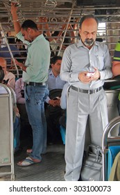 MUMBAI, INDIA - FEBRUARY 28, 2015: People Are Standing Inside Of Carriage Of Local Train In Mumbai