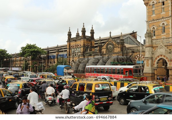 Mumbai, India - July 10th, 2017 - Big traffic jam\
in south Mumbai, A lot of taxis,private cars,public bus,\
motorcycles and many local people walking along the street in the\
busy road. India, Asia.