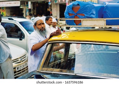 Mumbai, India, March, 03, 2016. A Taxi Driver Polishing His Old Car While Waiting For Customers.