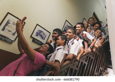 Mumbai, India - NOV 26, 2016: Indian High School Male Students Take Selfie With Teacher On Staircase During Field Trip