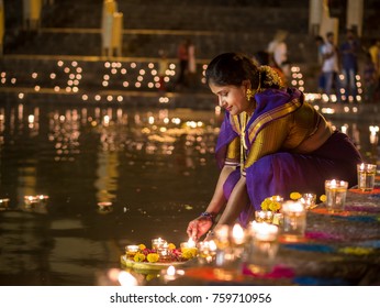 MUMBAI, INDIA - NOVEMBER 03 2017 : Traditional Indian Woman Lighting Diya During Diwali Festival In India 