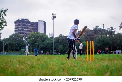 MUMBAI, INDIA - October 2, 2021 : Indias most famous sport Cricket played by kids at local Mumbai ground