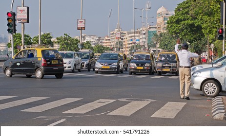 MUMBAI, INDIA - OCTOBER 24, 2016: Policeman on duty directing traffic in the south of the city. Mumbai, like many Indian cities, is often very congested and drivers have a reputation for poor driving