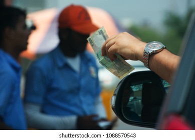 Mumbai, India-May 10 2018: Man With Rupee 100 Note Prepares To Pay Toll At A Toll Booth At Mumbai India.