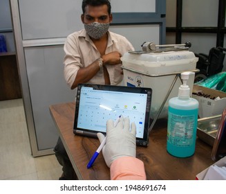 MUMBAI, MAHARASHTRA, INDIA - April 01, 2021: Health Workers Note Down Details On Tablet Of Citizens Who Have Taken Covid-19 Coronavirus Vaccine During The 3rd Phase At Shatabdi Hospital, Mumbai, MH