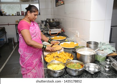 Mumbai; Maharashtra; India- Asia; April, 2019 : Indian Woman Making Gujarati Food Masala Puri